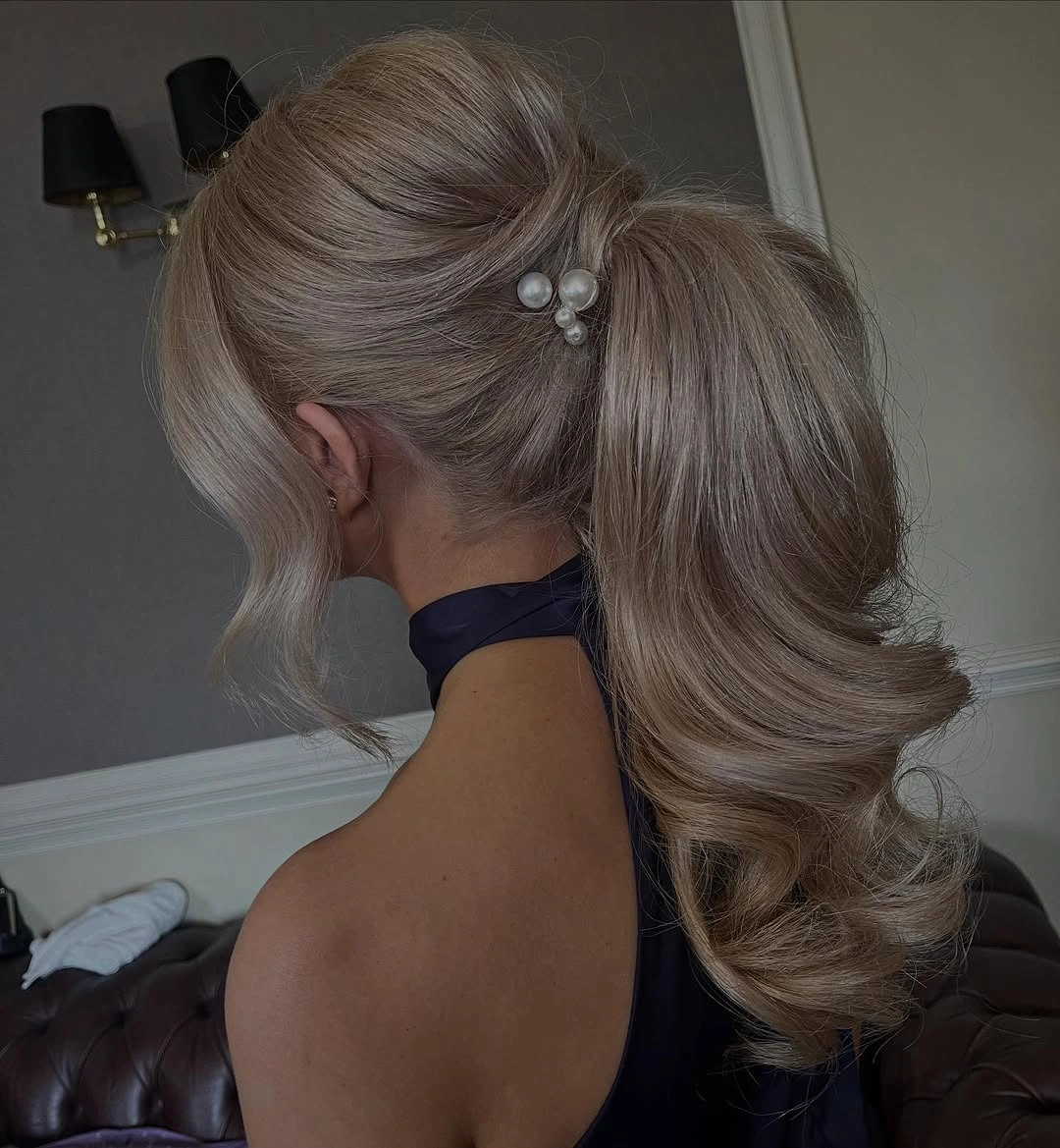 Fall hairstyles for wedding guests 2026 Classic Low Ponytail with Soft Hollywood Volume