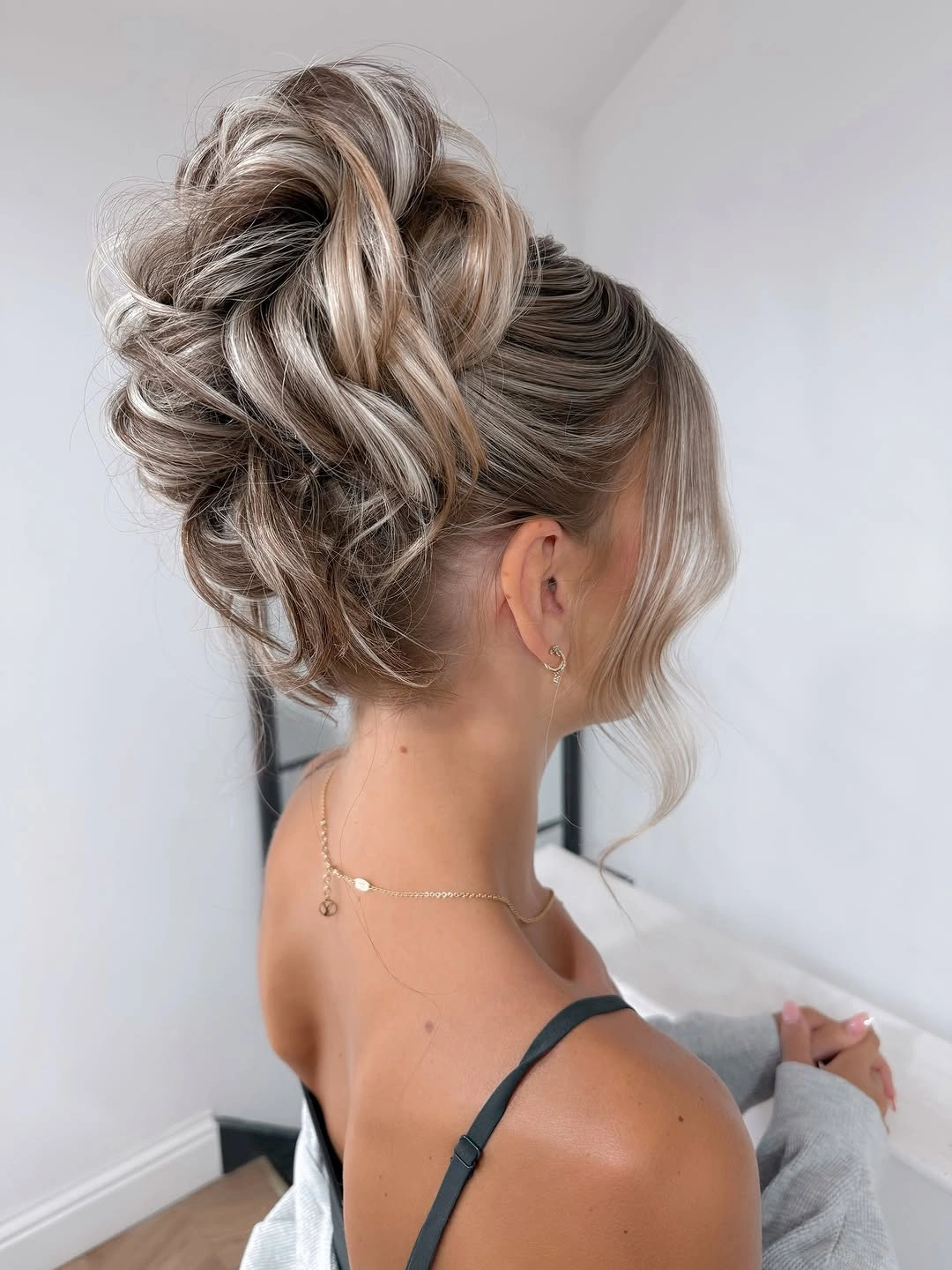 Fall hairstyles for wedding guests 2026 Textured Blonde Updo with Airy Volume