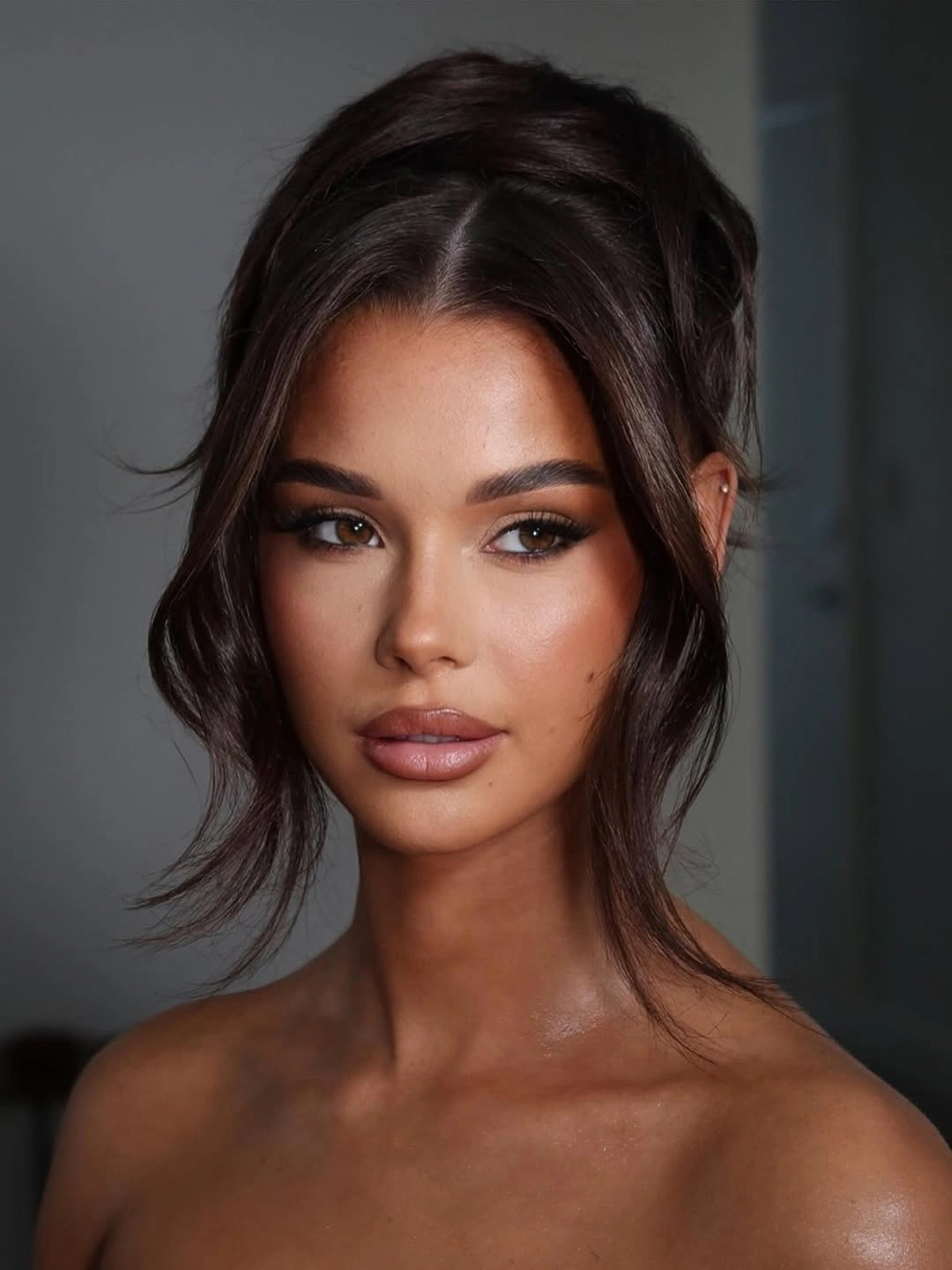 Fall hairstyles for wedding guests 2026 Relaxed Brunette Updo with Wispy Curtain Pieces