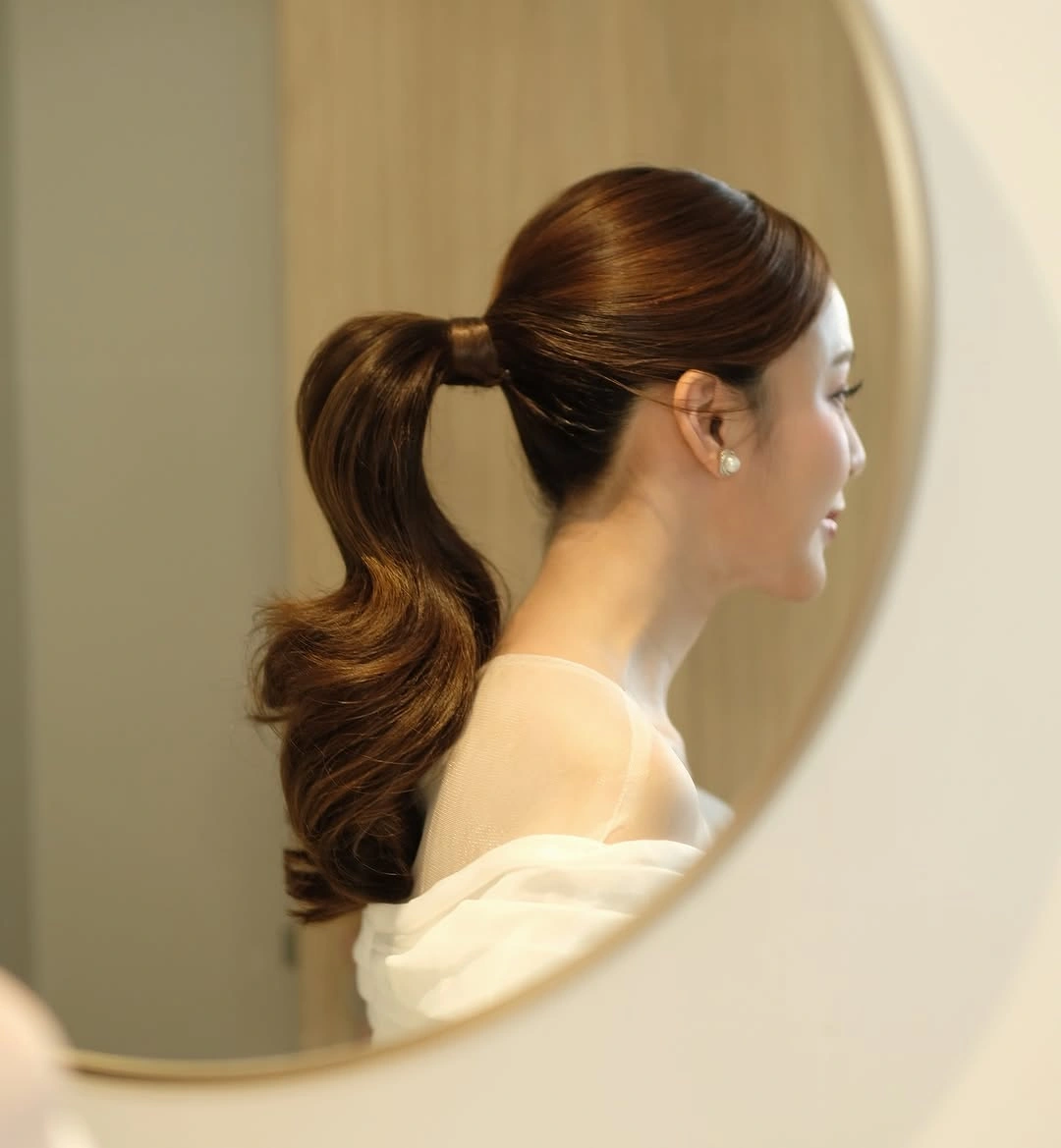 Fall hairstyles for wedding guests 2026 Classic Wrapped Ponytail with Smooth Hollywood Volume