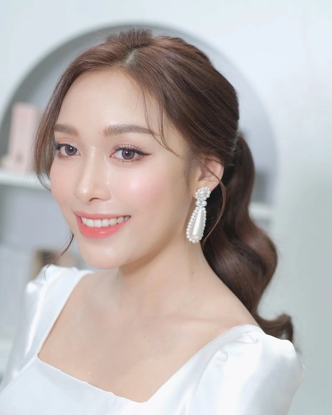 Fall hairstyles for wedding guests 2026 Soft Low Ponytail with Face-Framing Layers
