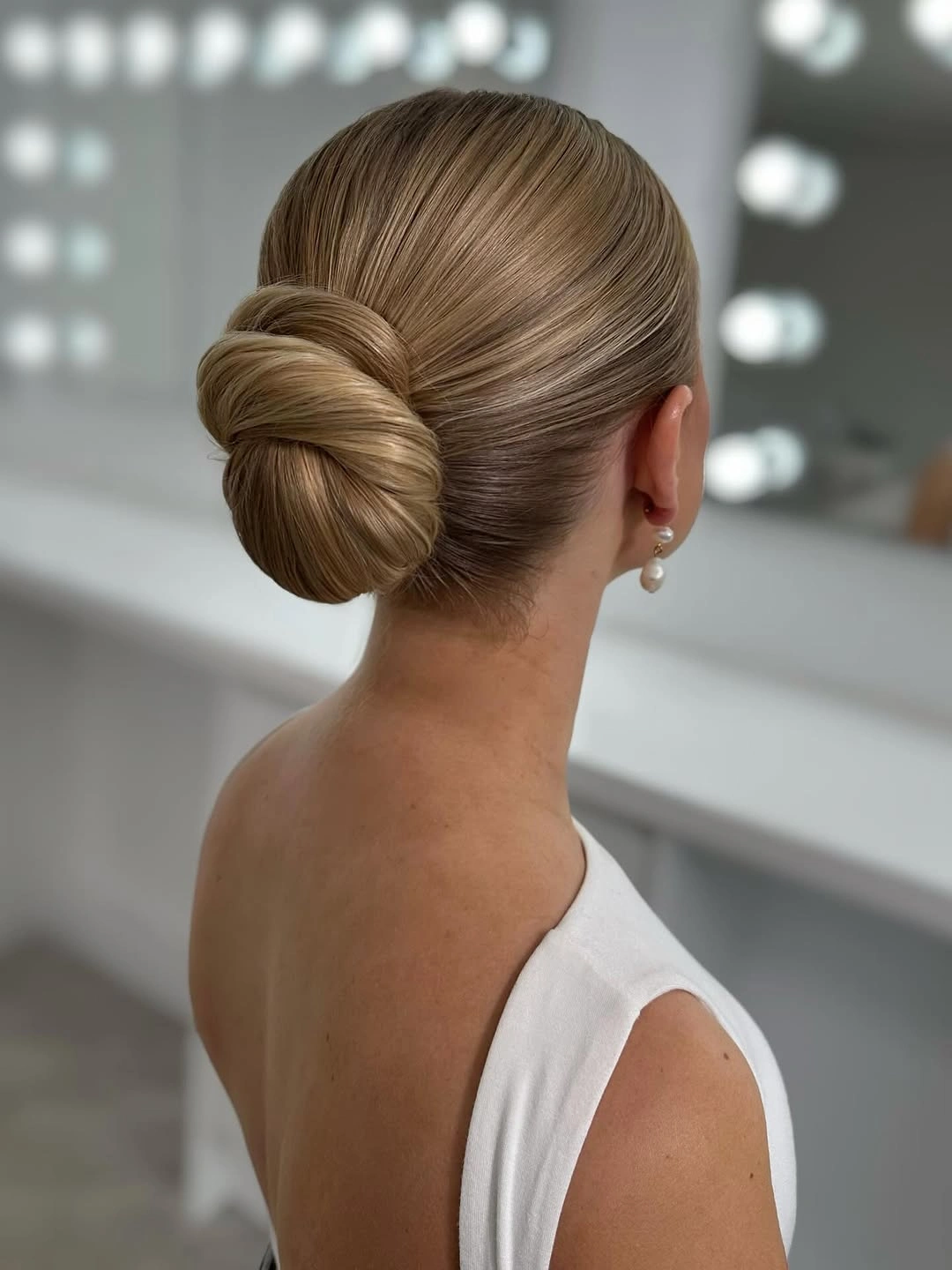 Fall hairstyles for wedding guests 2026 Classic Sleek Chignon for Timeless Elegance
