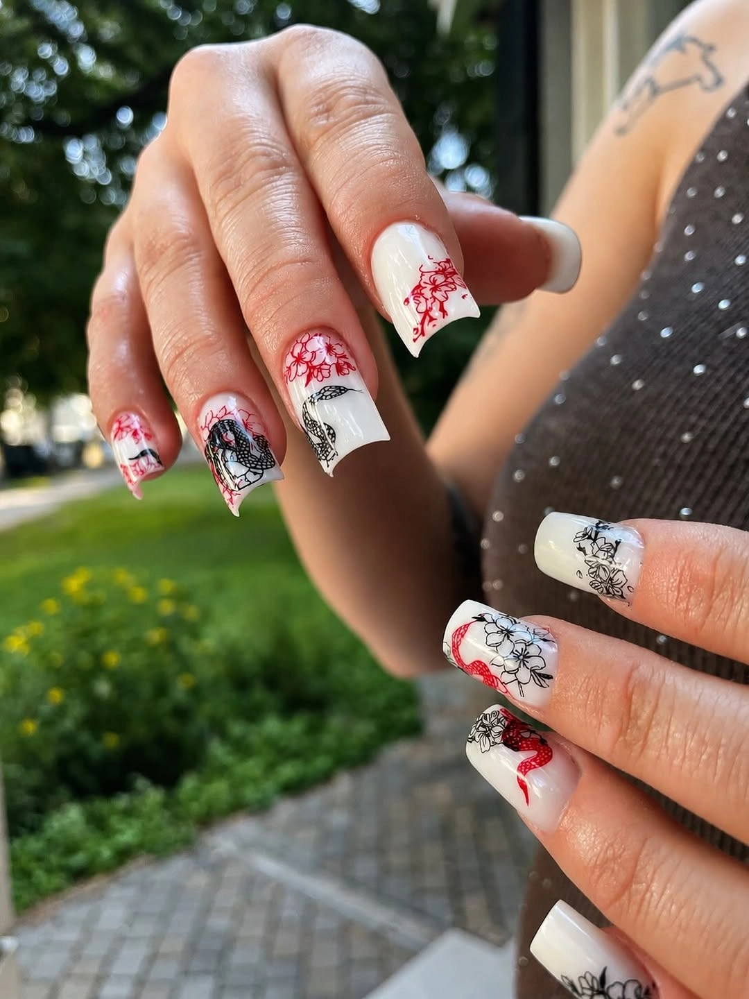 Fall manicure 2026 Red and Black Floral Print Manicure on White Nails