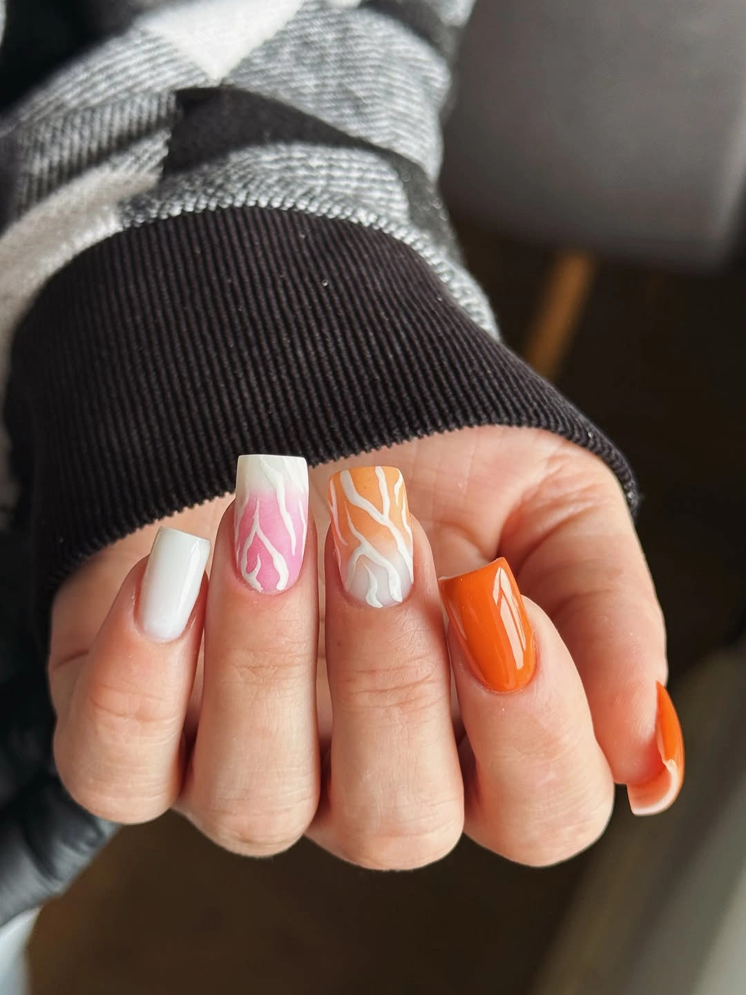 Fall manicure 2026 Orange and Pink Swirl Manicure With White Accents
