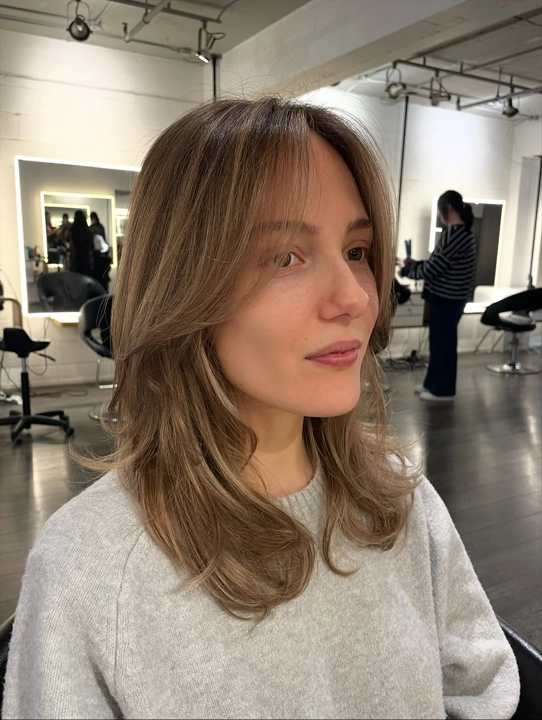 fall medium haircuts 2026 Soft Feathered Layers With Modern Curtain Framing