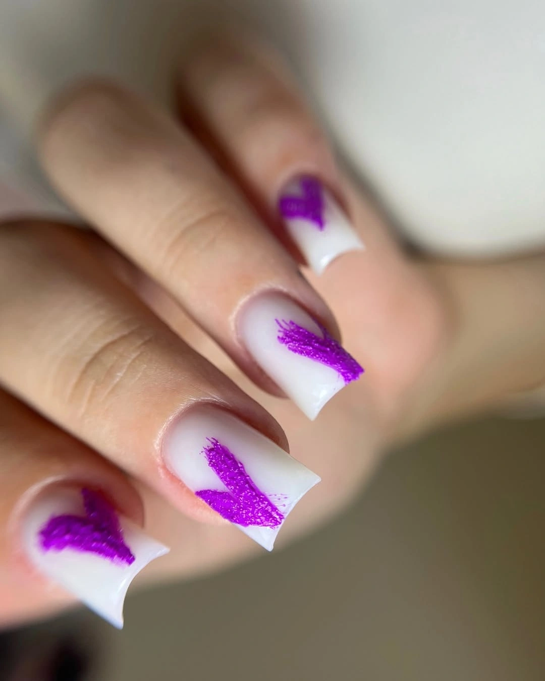 white medium square nails with glittery purple brushstroke accents