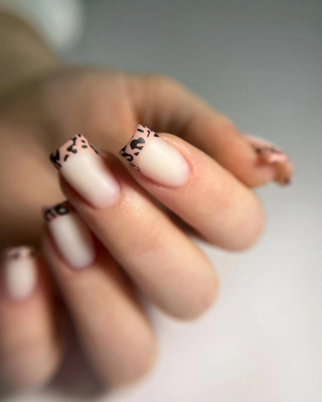 milky pink medium square nails with animal-print tips