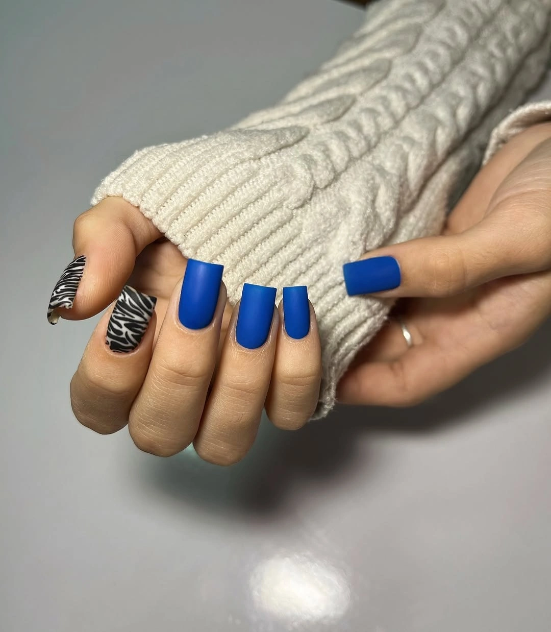 matte blue medium square nails with zebra-print accent nails