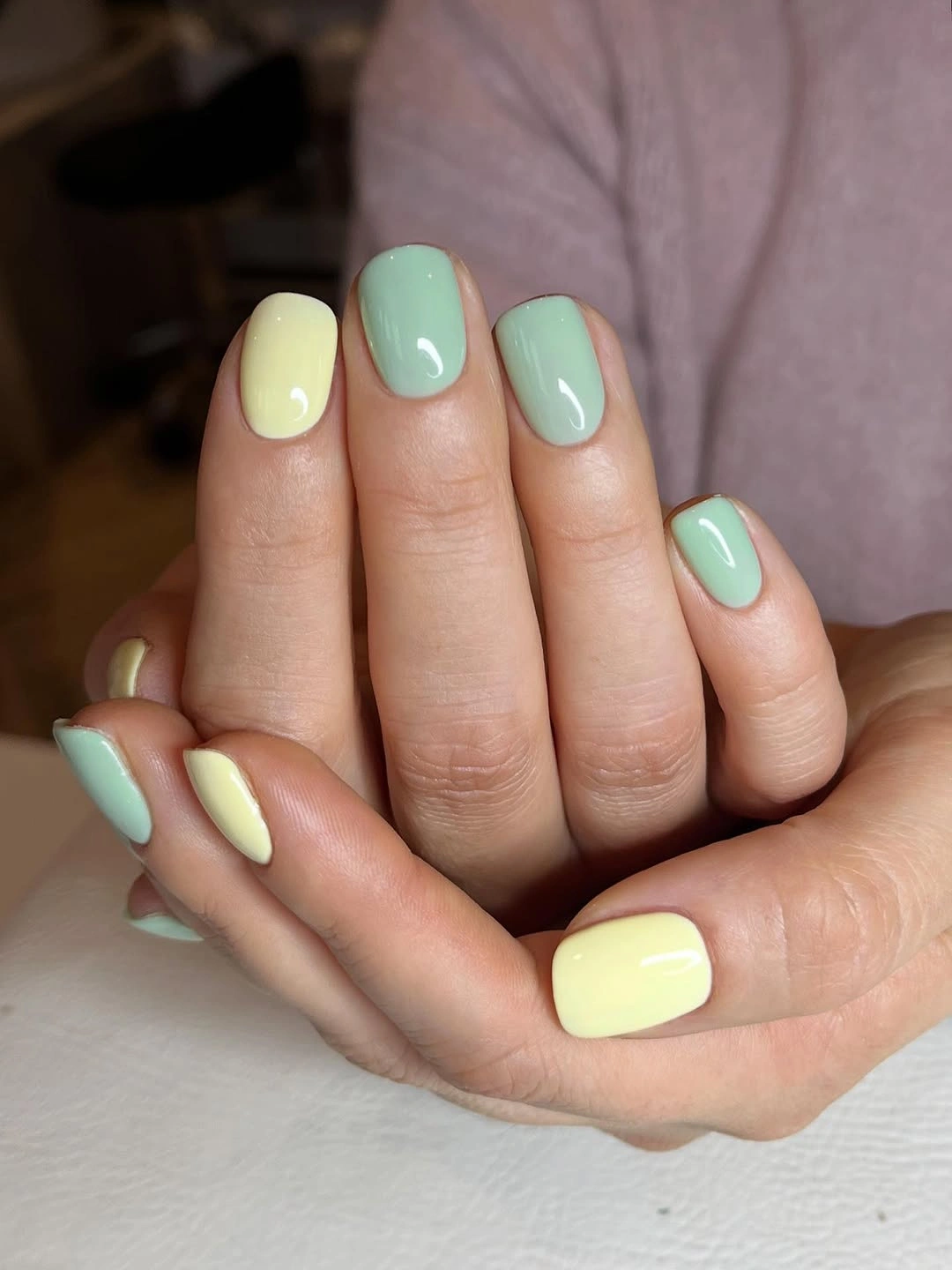 mint green and pale lemon yellow rounded square nails with alternating solid colors