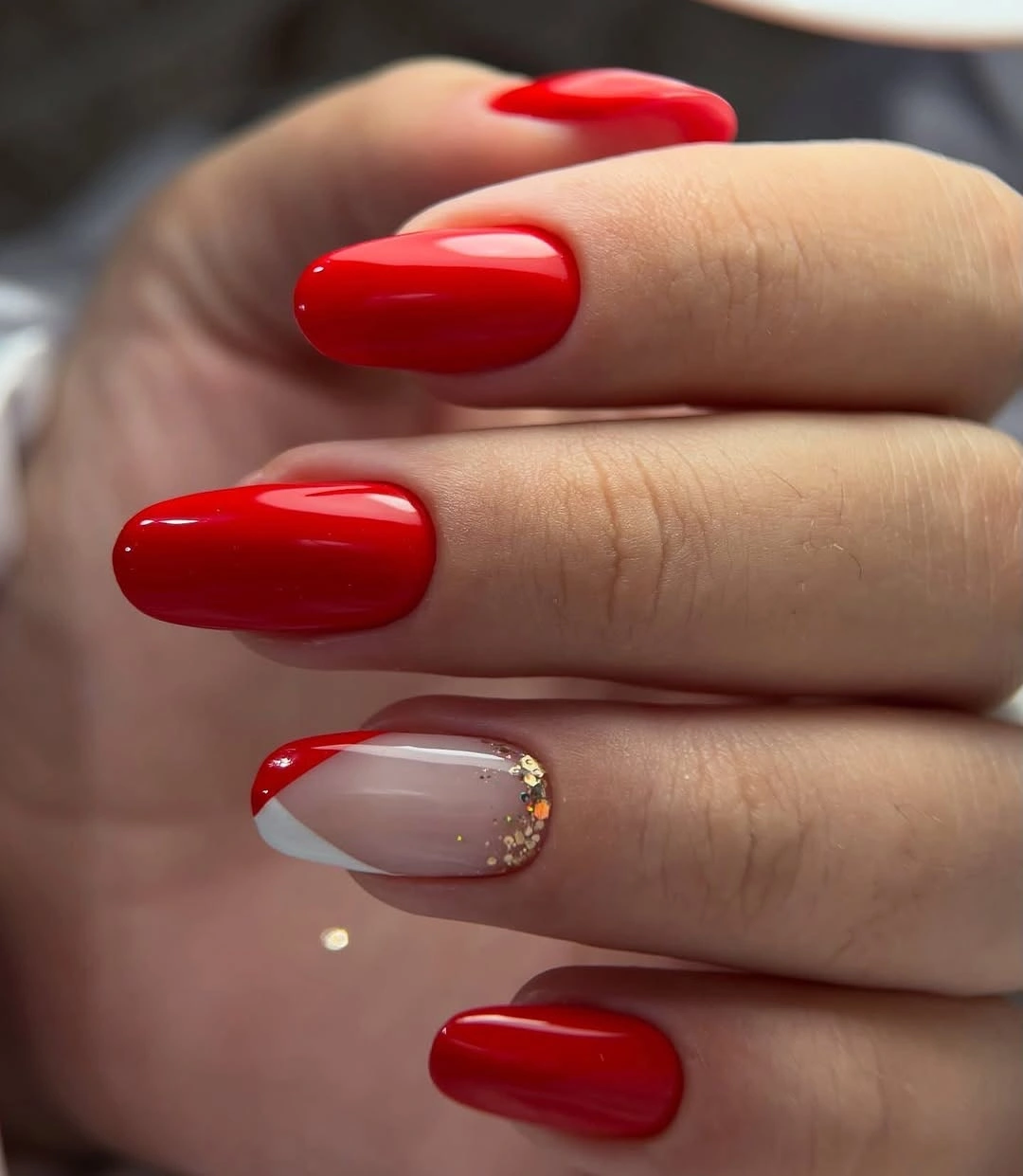 Fall nail art 2026 Glossy Red Almond Nails With a Gold Accent