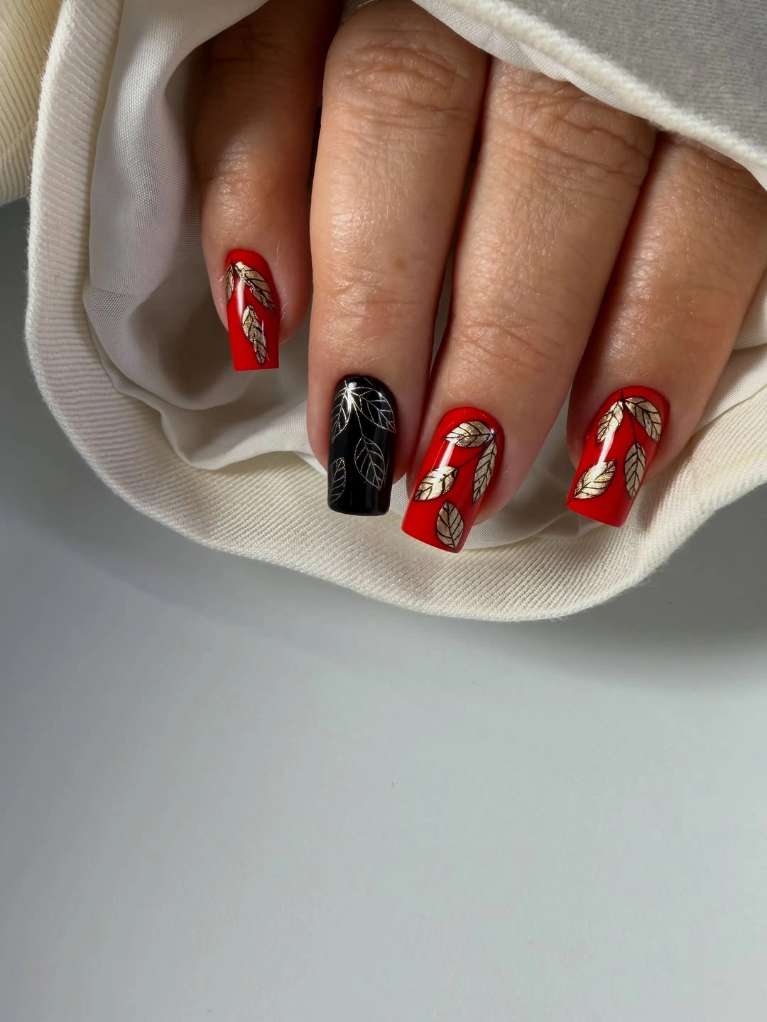 Fall nail art 2026 Red and Black Nails With Gold Foil Collage