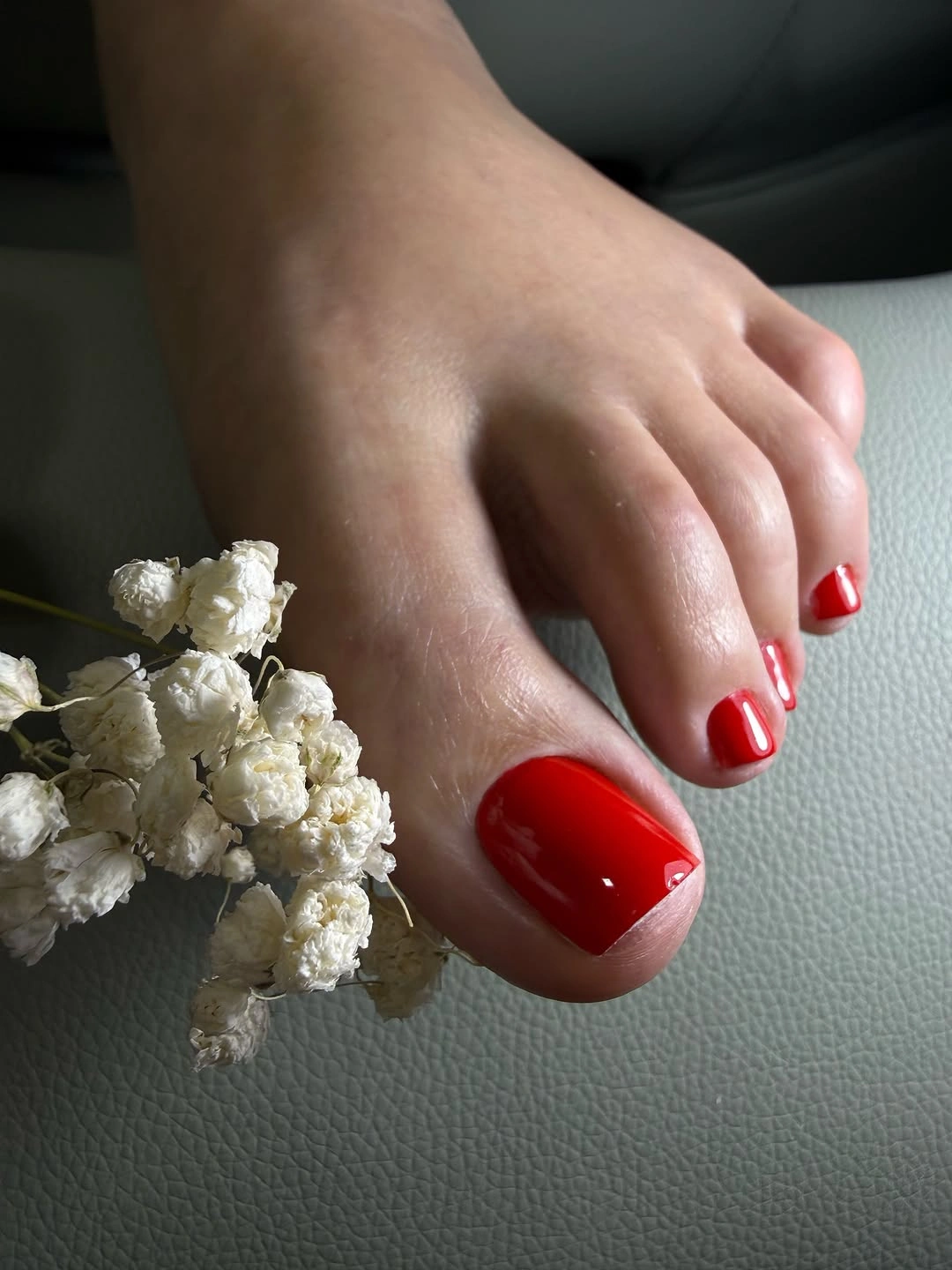 saturated red pedicure on compact square toenails