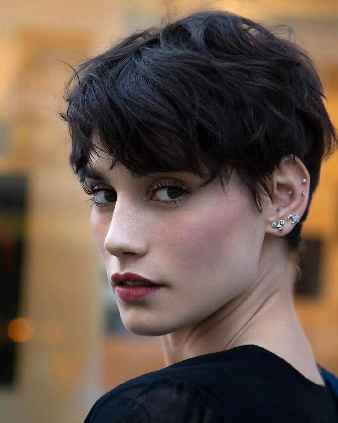 fall short haircuts 2026 Textured Brunette Pixie with Soft Curtain Bangs
