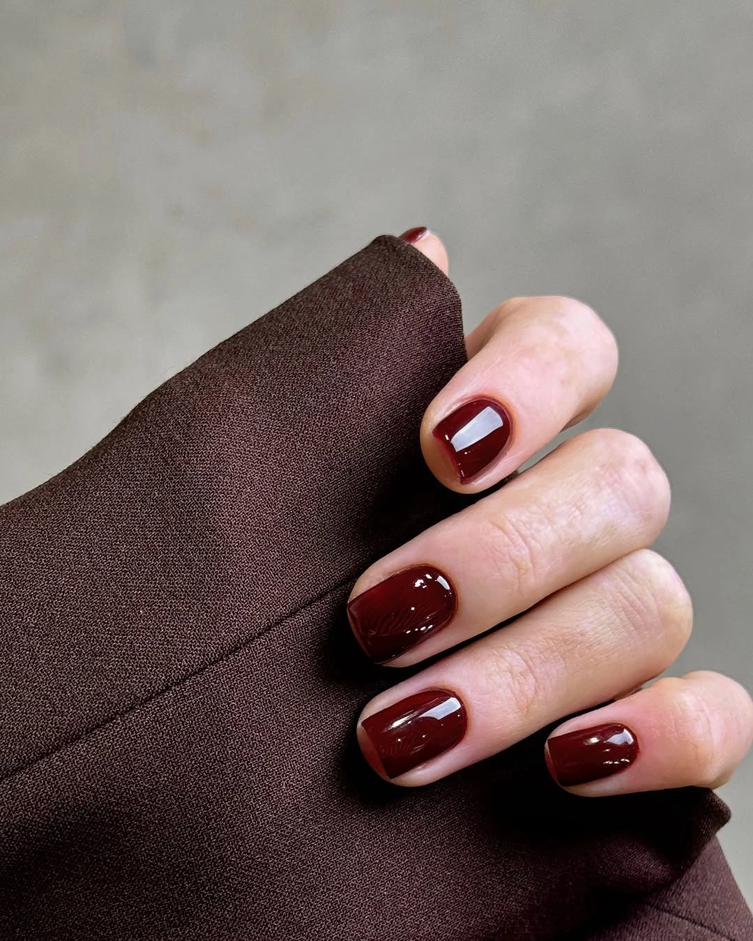 Fall short nails 2026 Cherry Wine Nails With a Tiny Negative-Space Edge