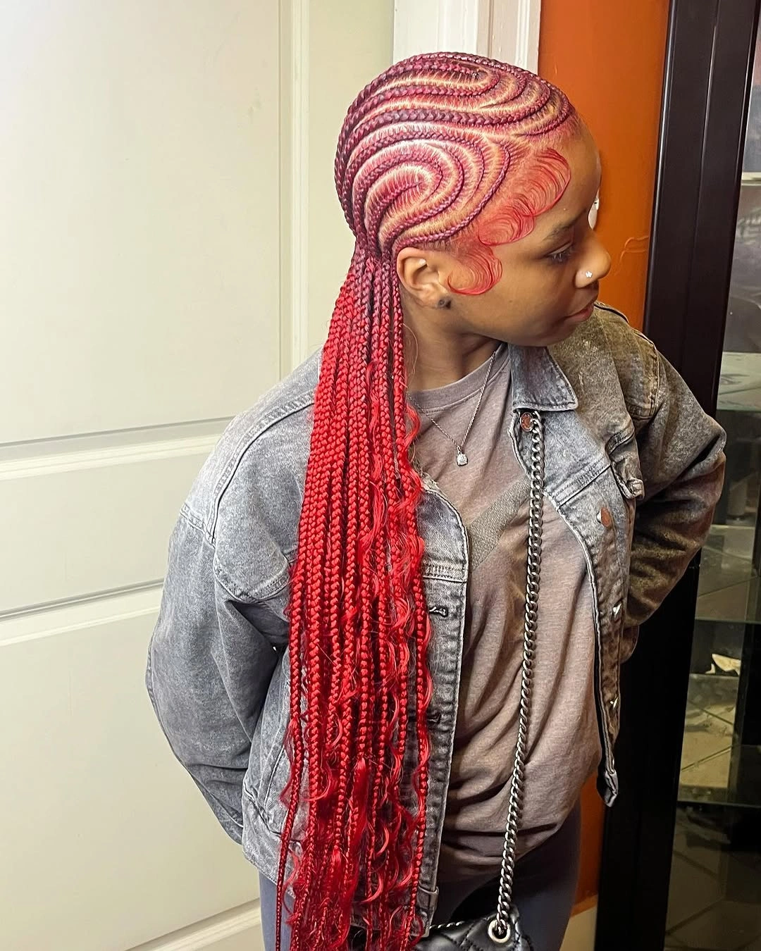 feed in braid hairstyles Bold Crimson Feed-In Braids with Artistic Wave Patterns