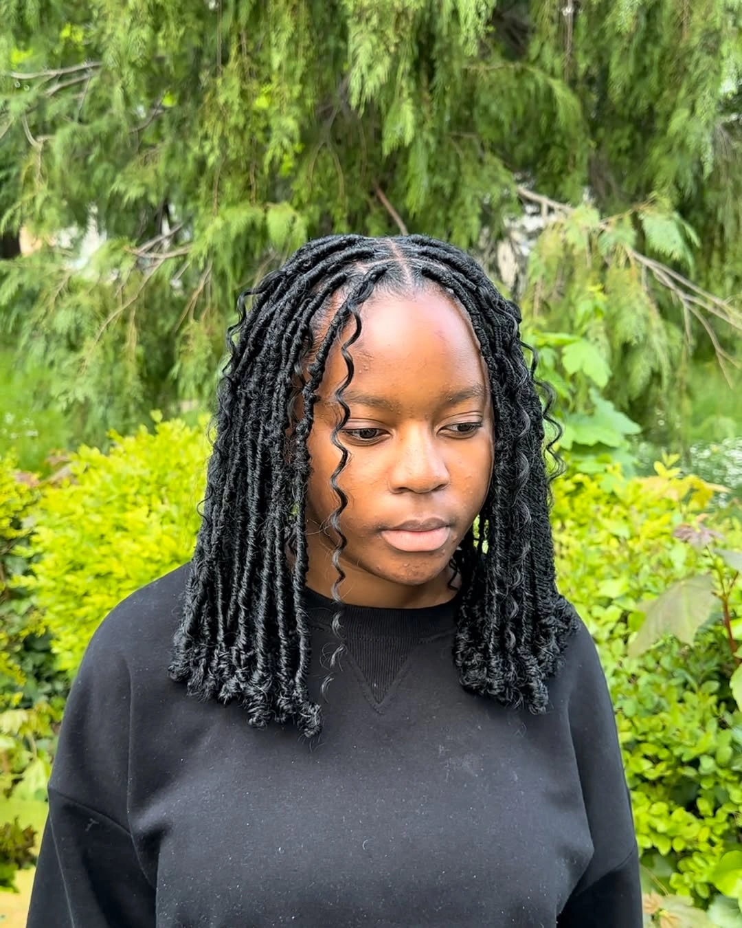 locs hairstyles for black women Playful Curled Loc Bob With Youthful Volume