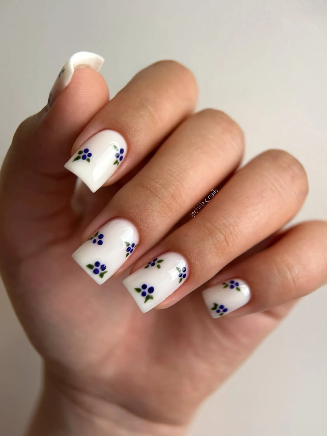 September nail art ideas 2026 White Square Nails With Tiny Blue Yellow Flowers