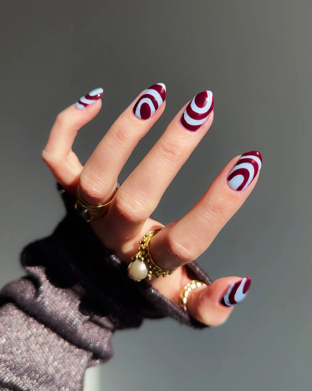 September nail art ideas 2026 Burgundy And Navy Swirls On Almond Nails