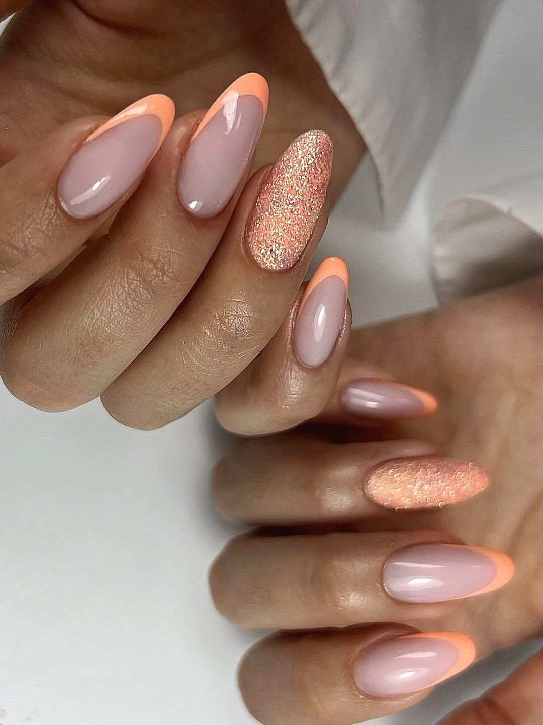 September nails color 2026 Sheer Pink Almond Nails With Peach Glitter
