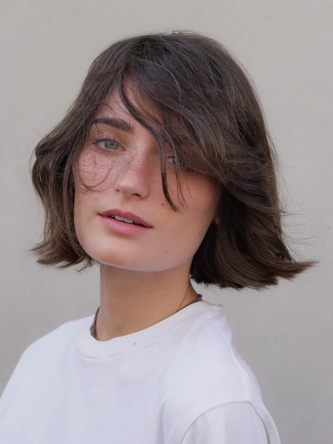 short bobbed hairstyle Flipped Brunette Bob With Long Fringe
