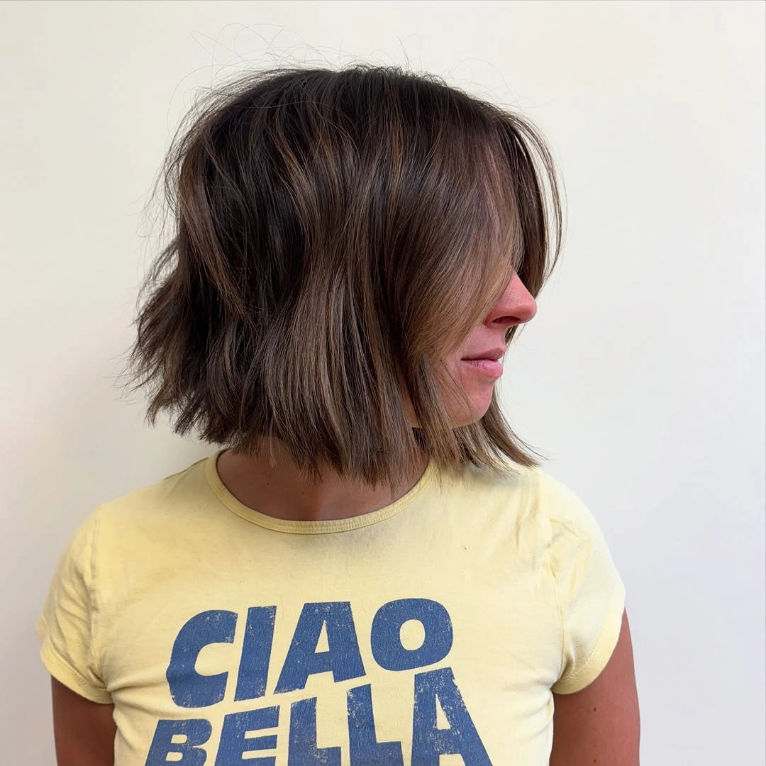 short bobbed hairstyle Textured Brown Bob With Side-Swept Layers