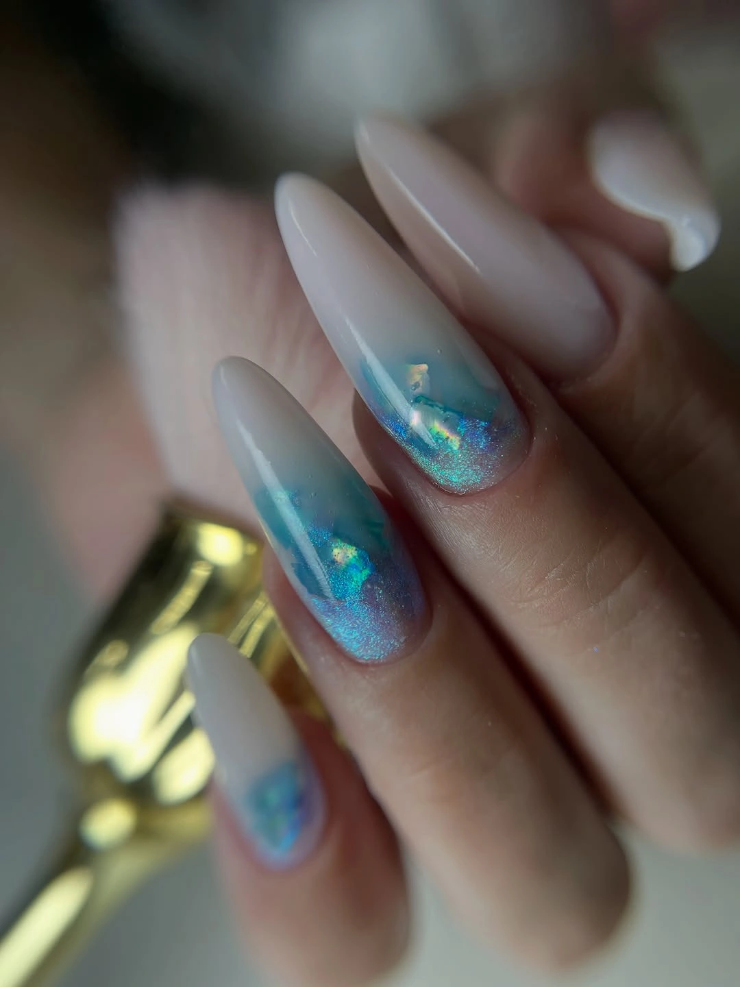 Long translucent pale nails with blue reflective tips