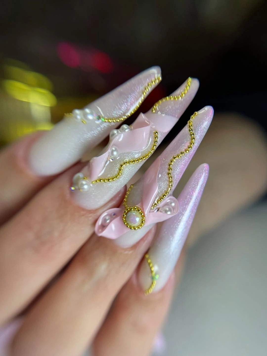Long white lavender nails with curved gold details