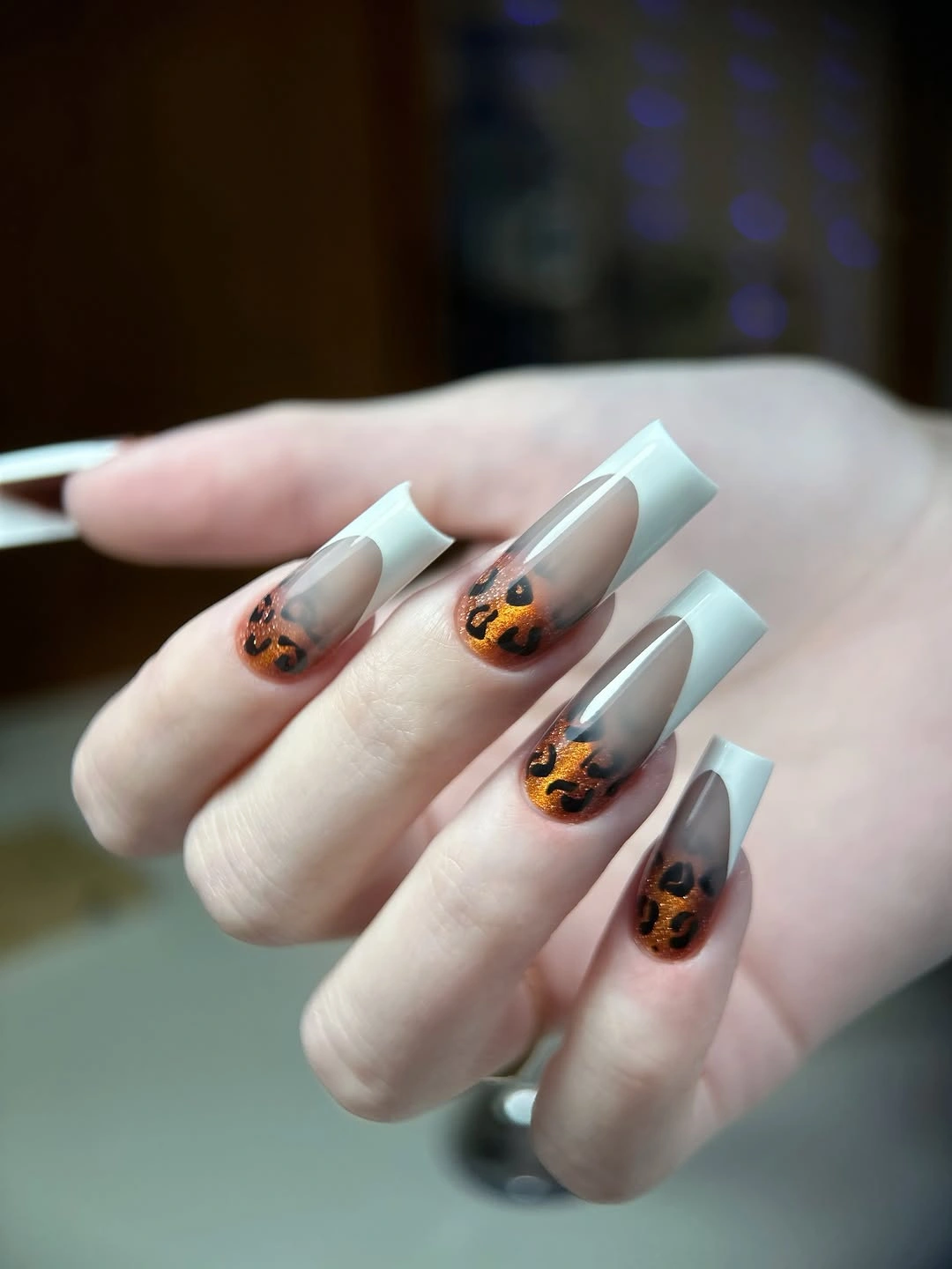 Long translucent square nails with warm spotted tips