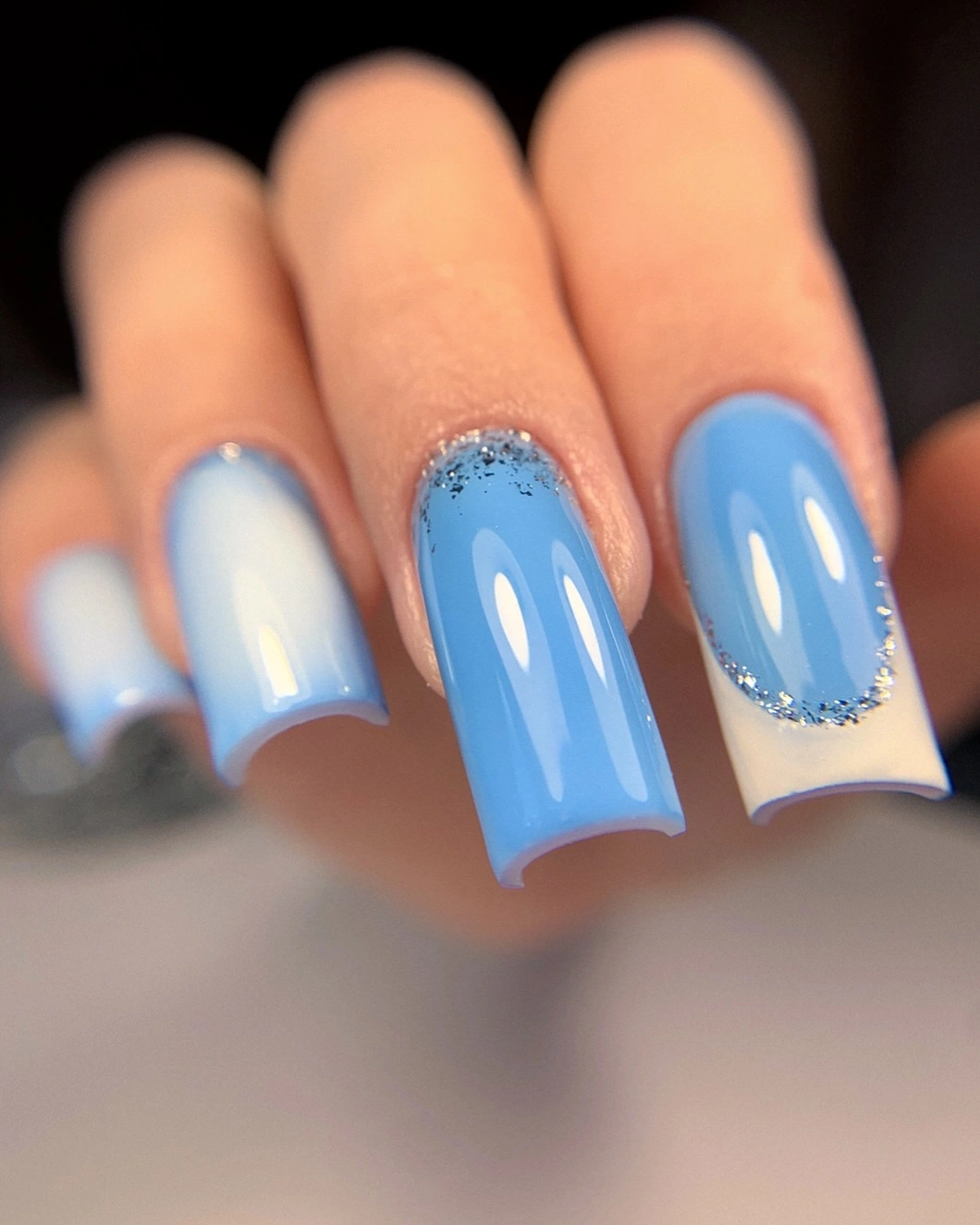 Blue white nails with pale sections and reflective edges