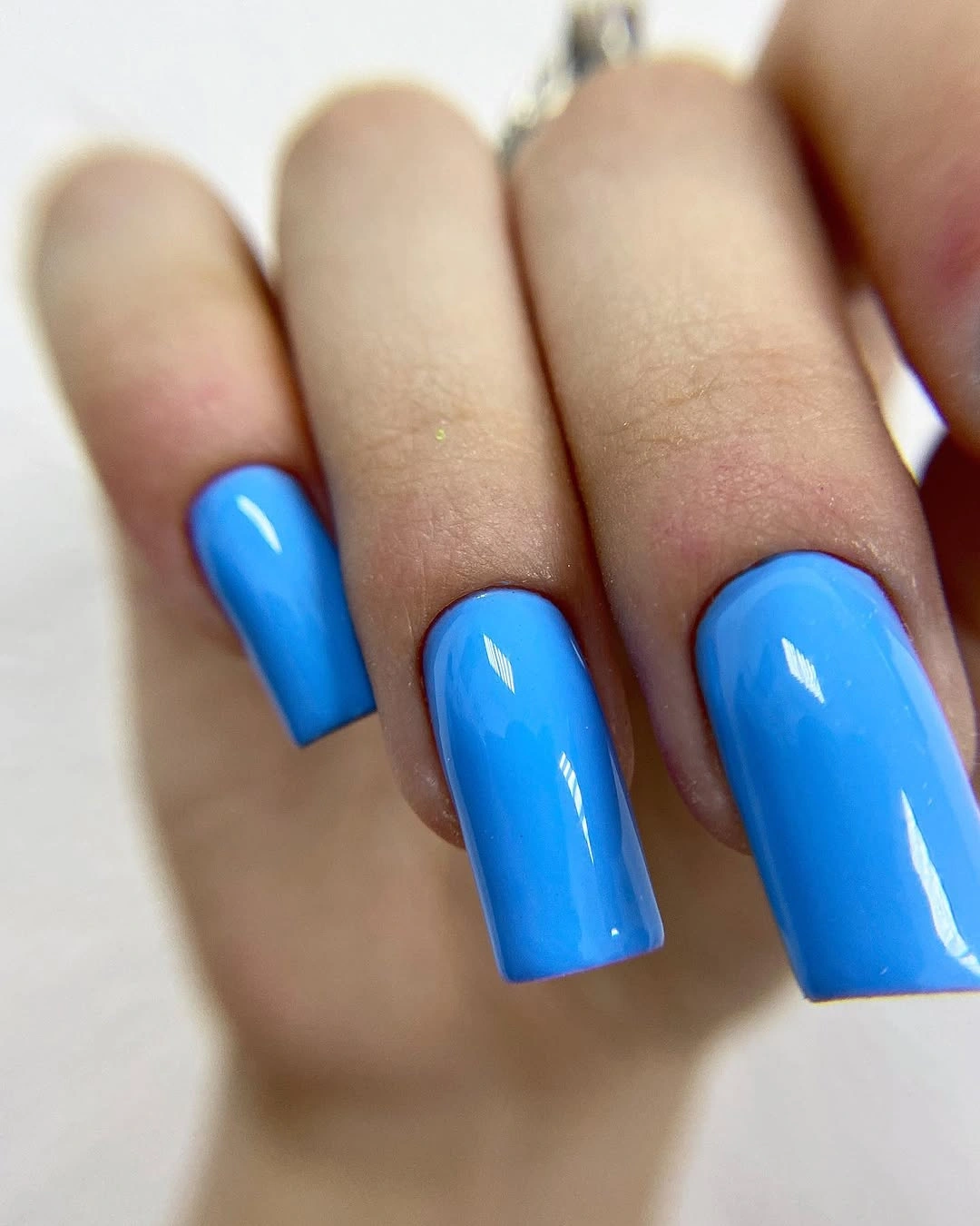 Medium-long glossy cobalt-blue square nails with bright shine
