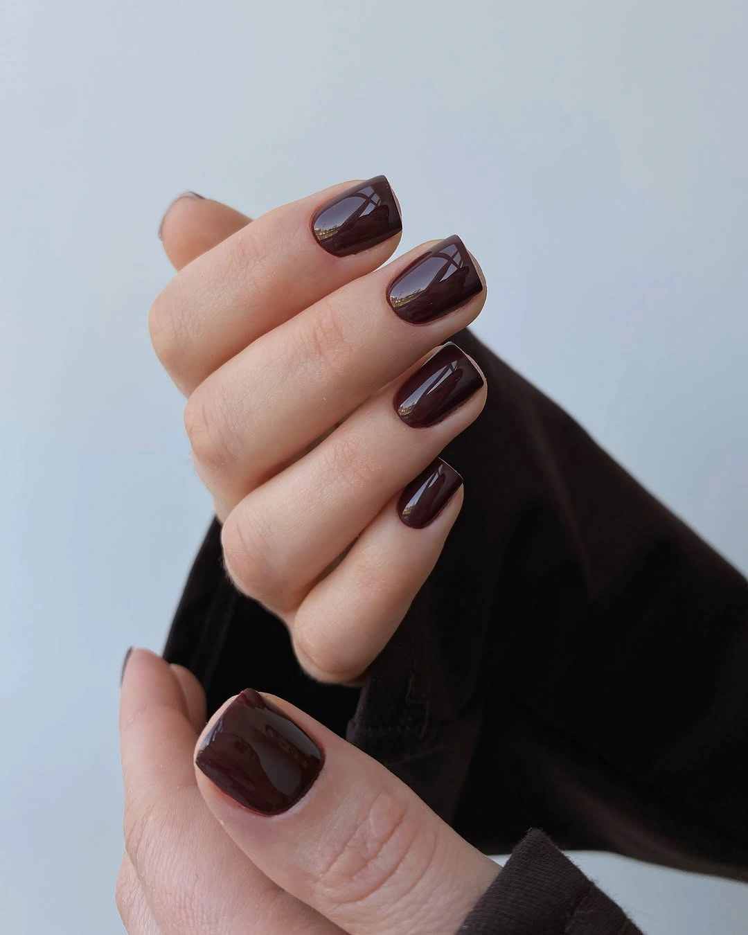 long almond nails with almost black chocolate gloss