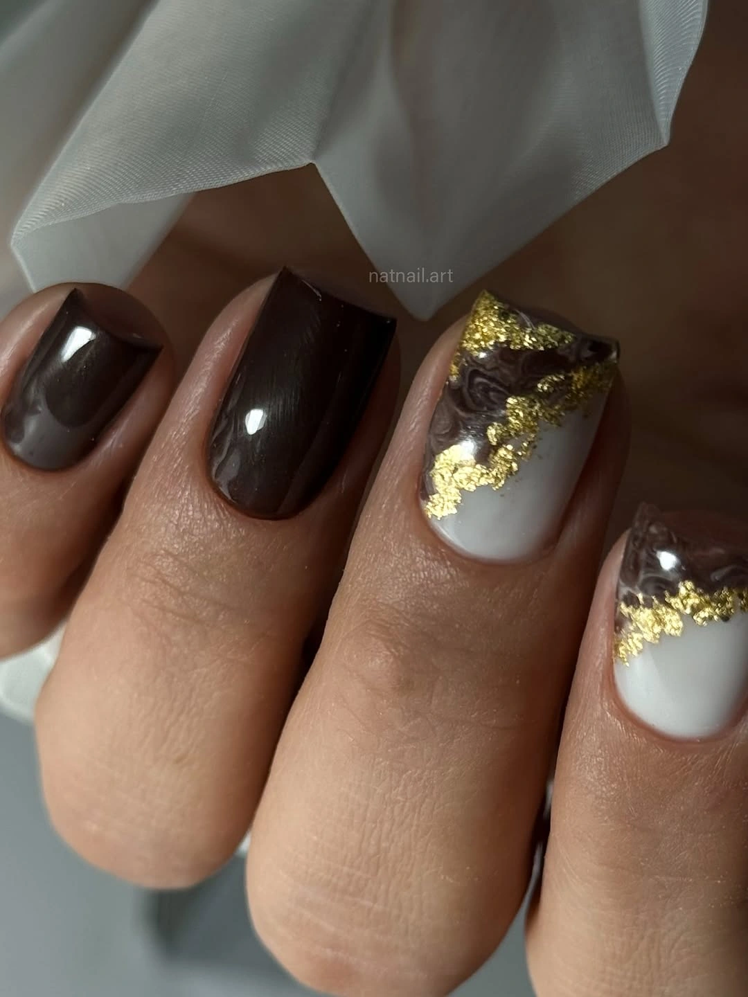 short squoval nails in glossy black brown with warm styling