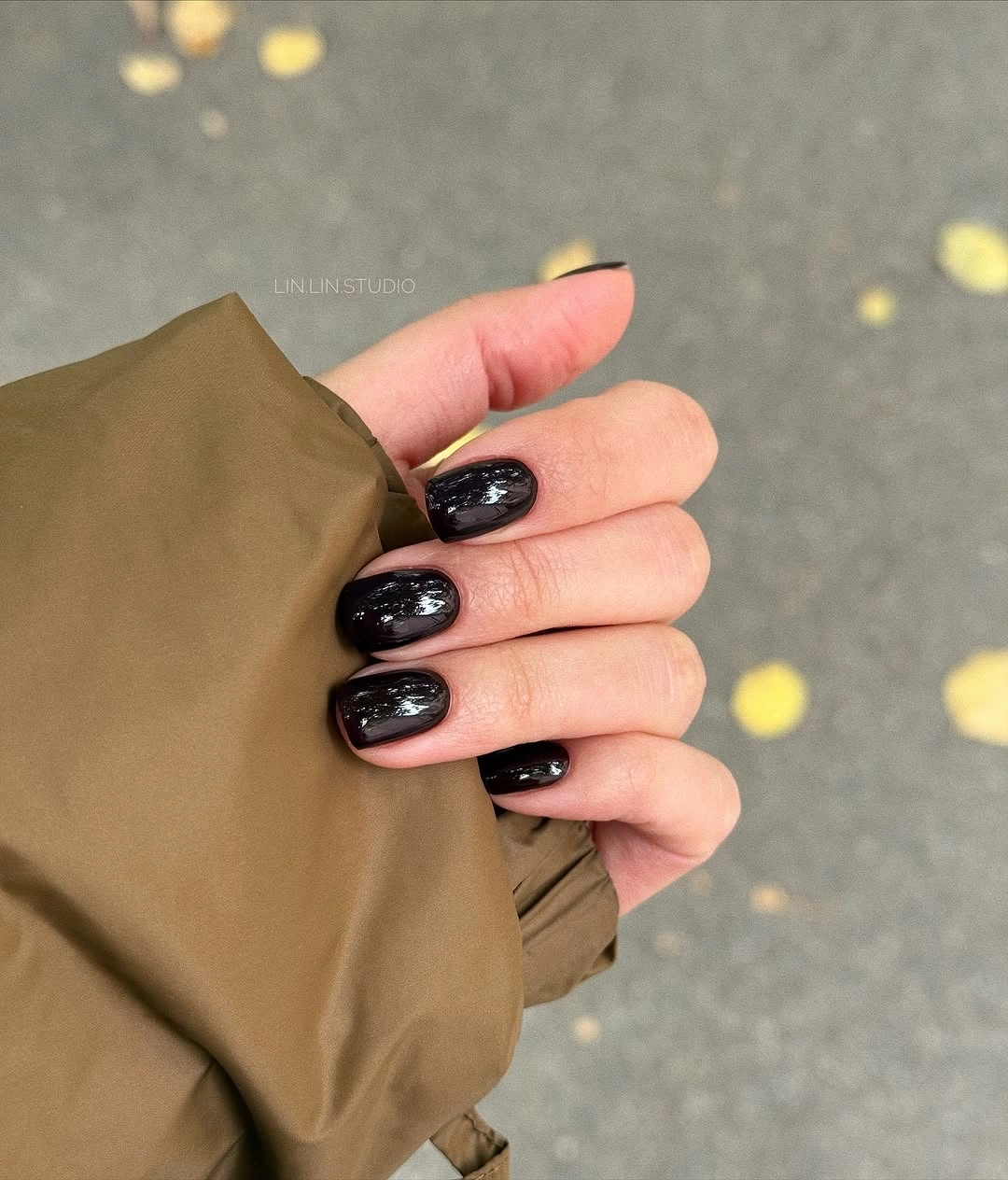 medium almond nails with nude bases and brown curved tips