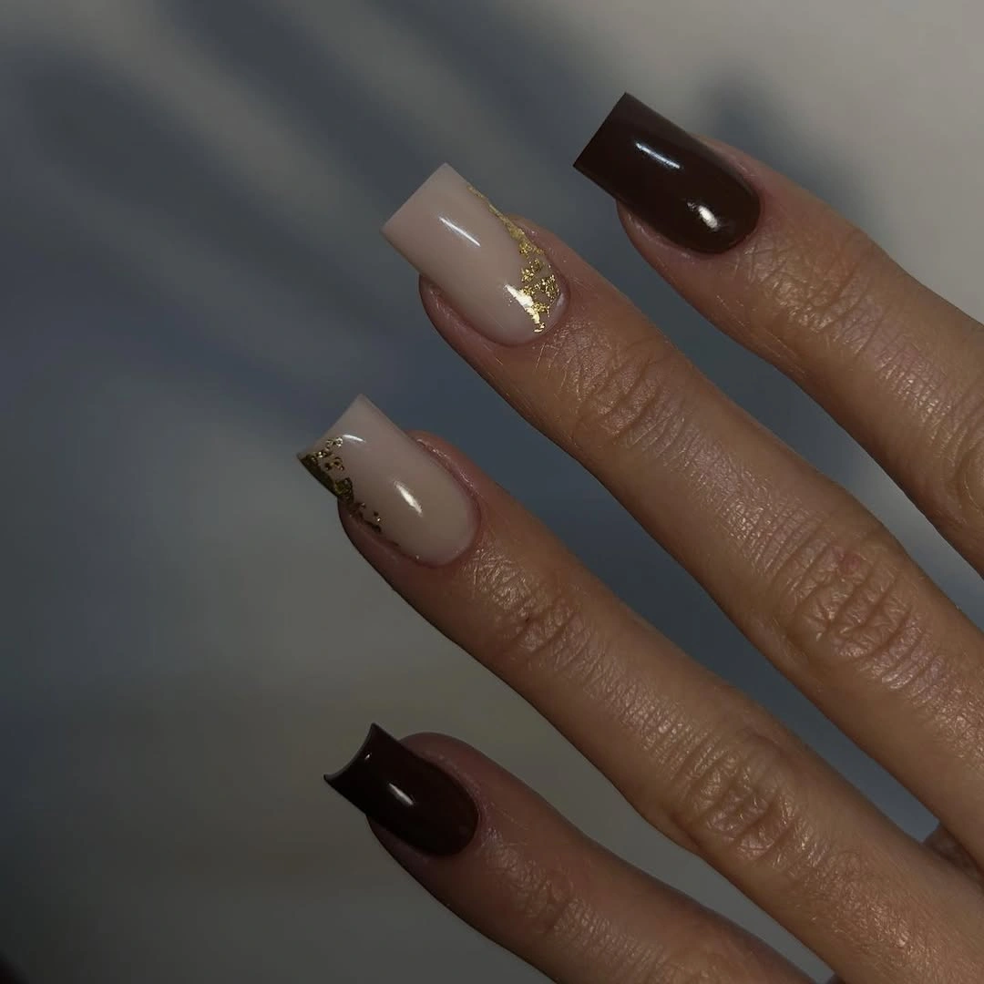 short square milky nails with brown spotted accents