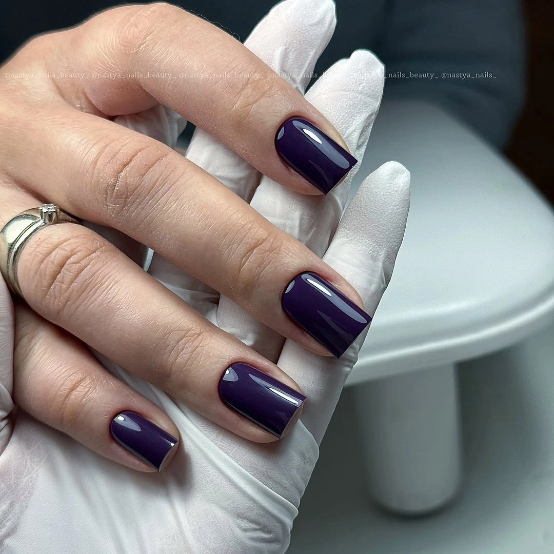 Short glossy deep violet rounded-square dark fall nails