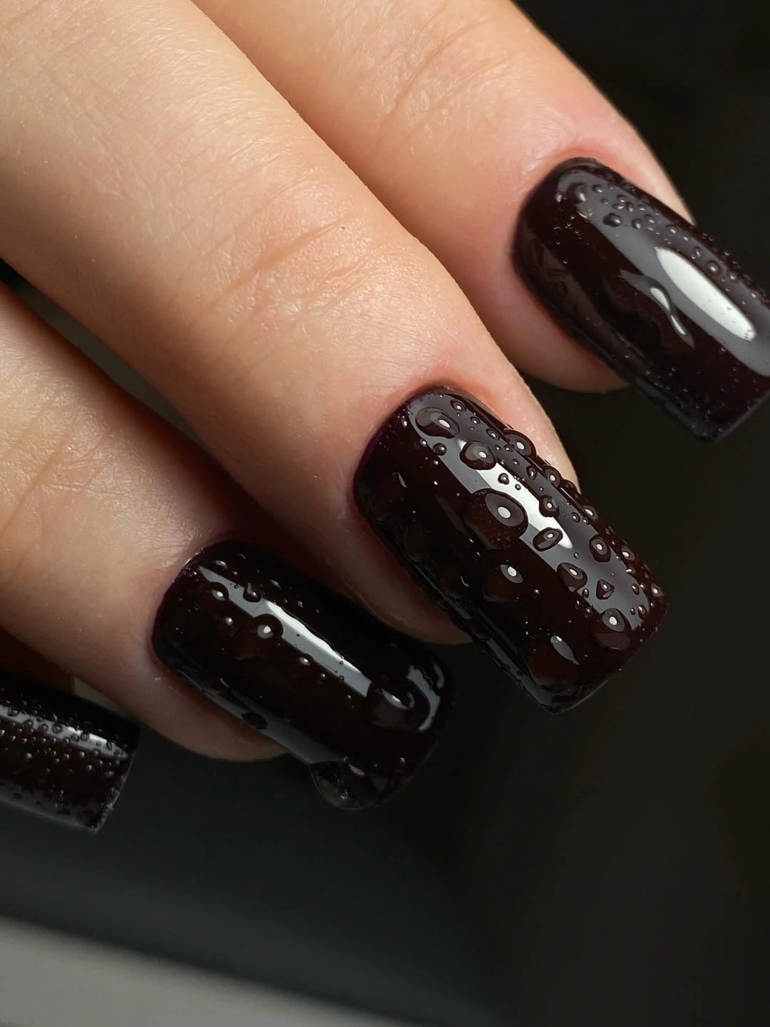 Short espresso nails with small raised silver accent details