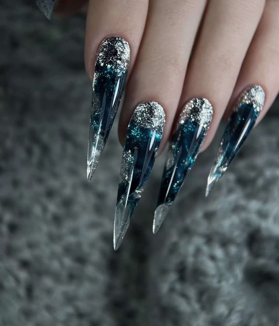 Long blue-black stiletto nails with silver glitter tips