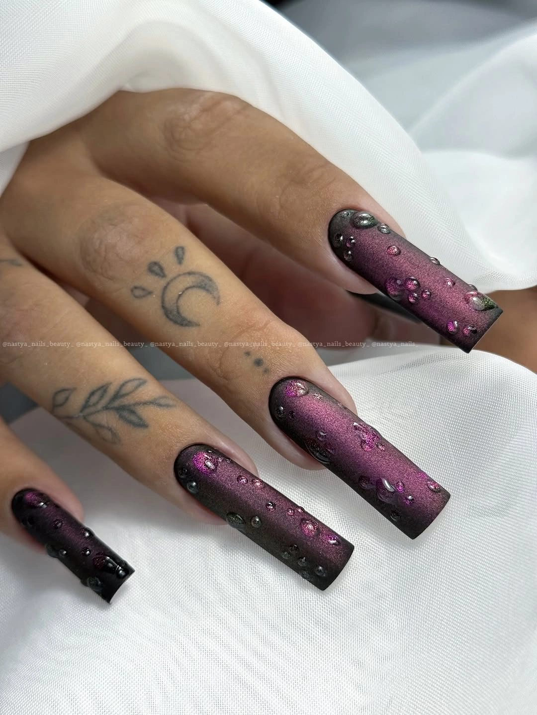 Long plum-black glitter nails with dense reflective detail