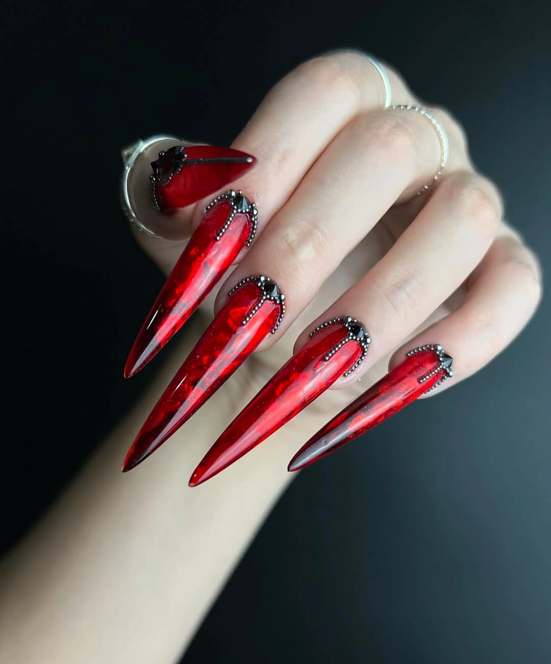 Long reflective red stiletto nails with black framing details