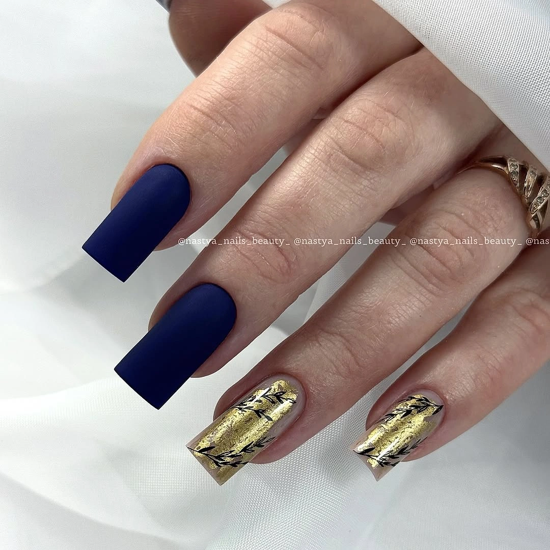 Long matte navy square nails with two bright gold accents
