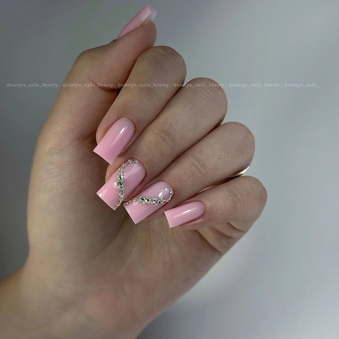 Medium pink almond nails with delicate metallic line accents