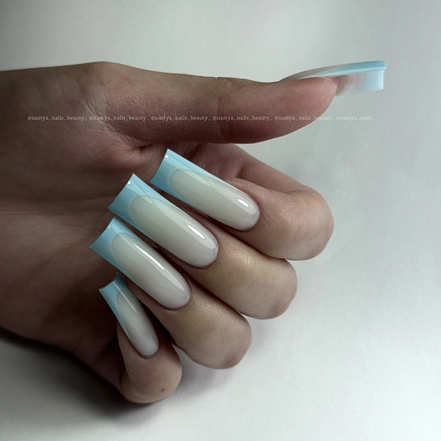 Long almond nails in a cool pale blue and milky finish