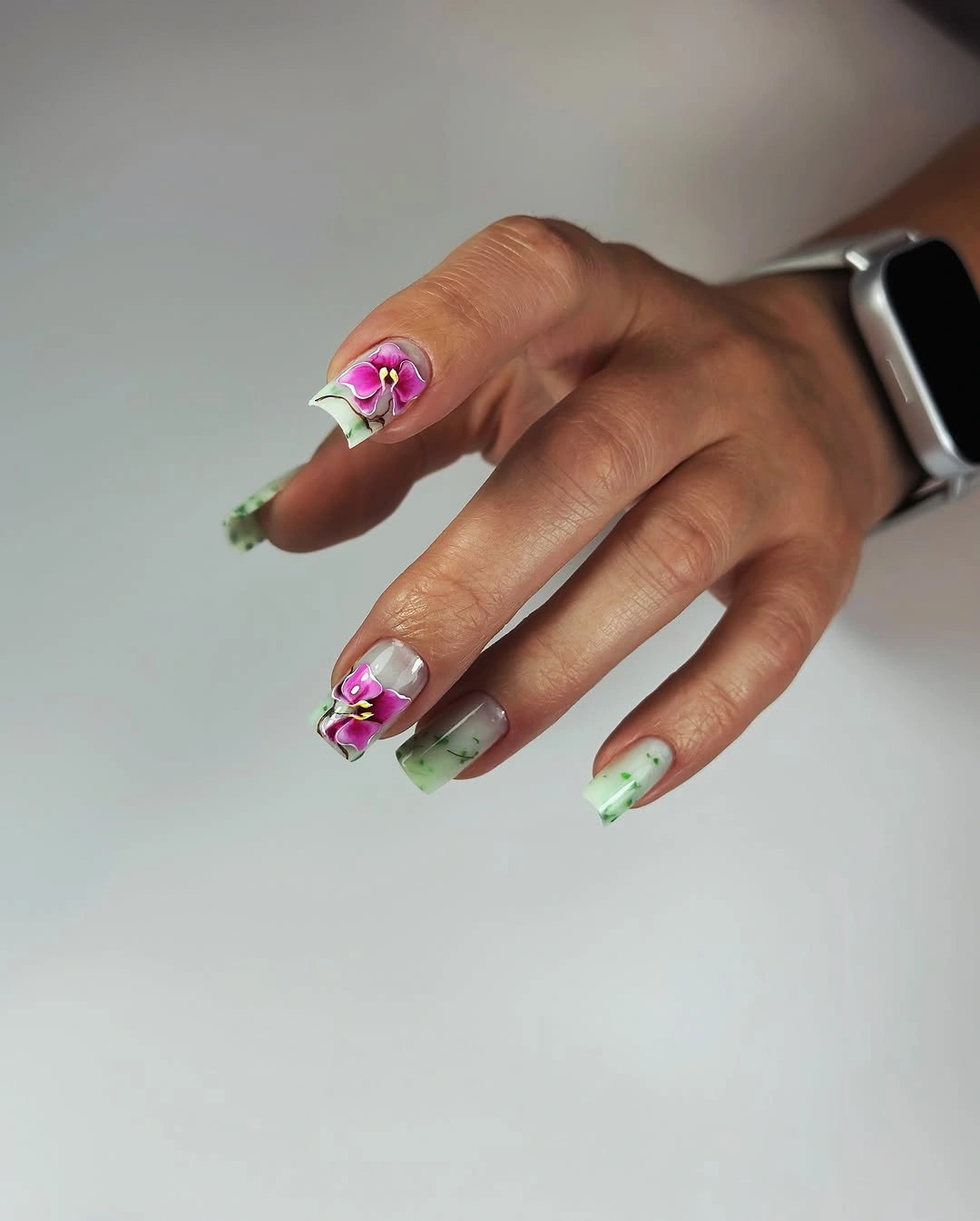 Medium square mint tipped nails with pink floral accents