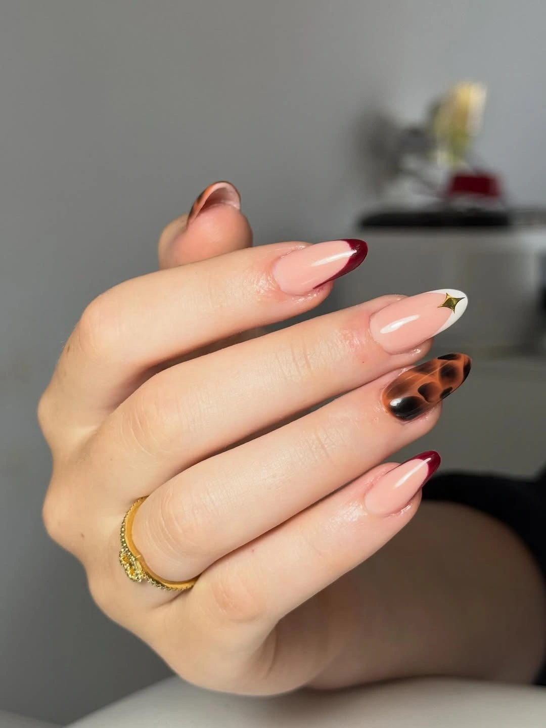 Long almond pale pink nails with red green and spotted accents