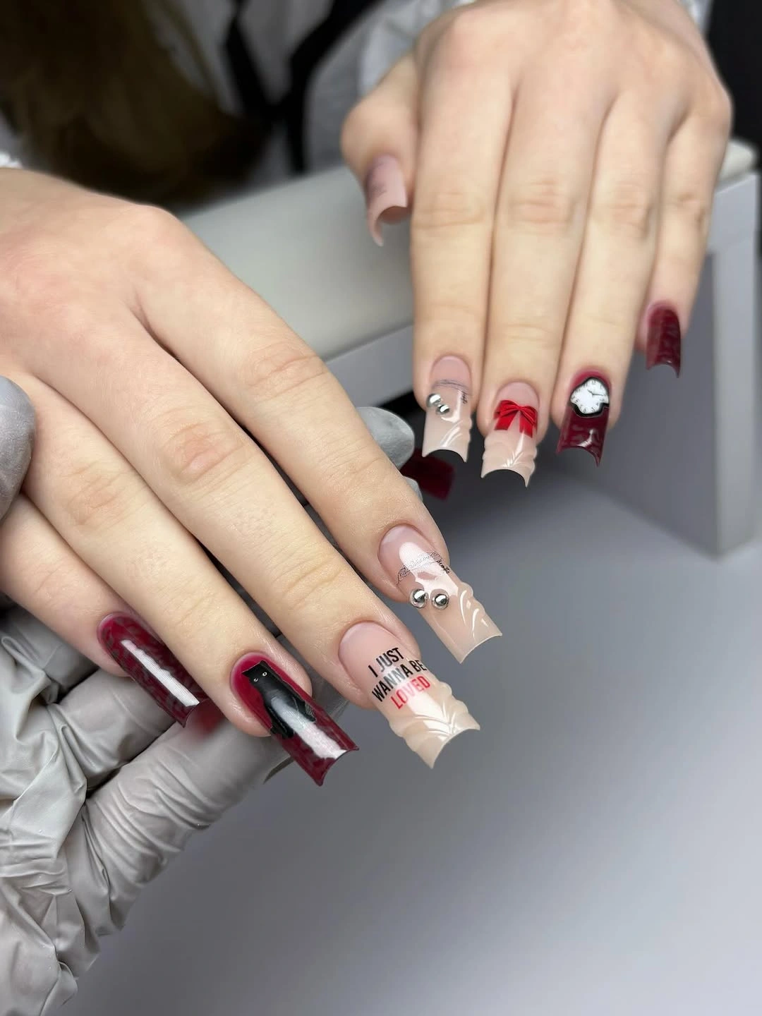 Long square burgundy nude and white graphic accent nails