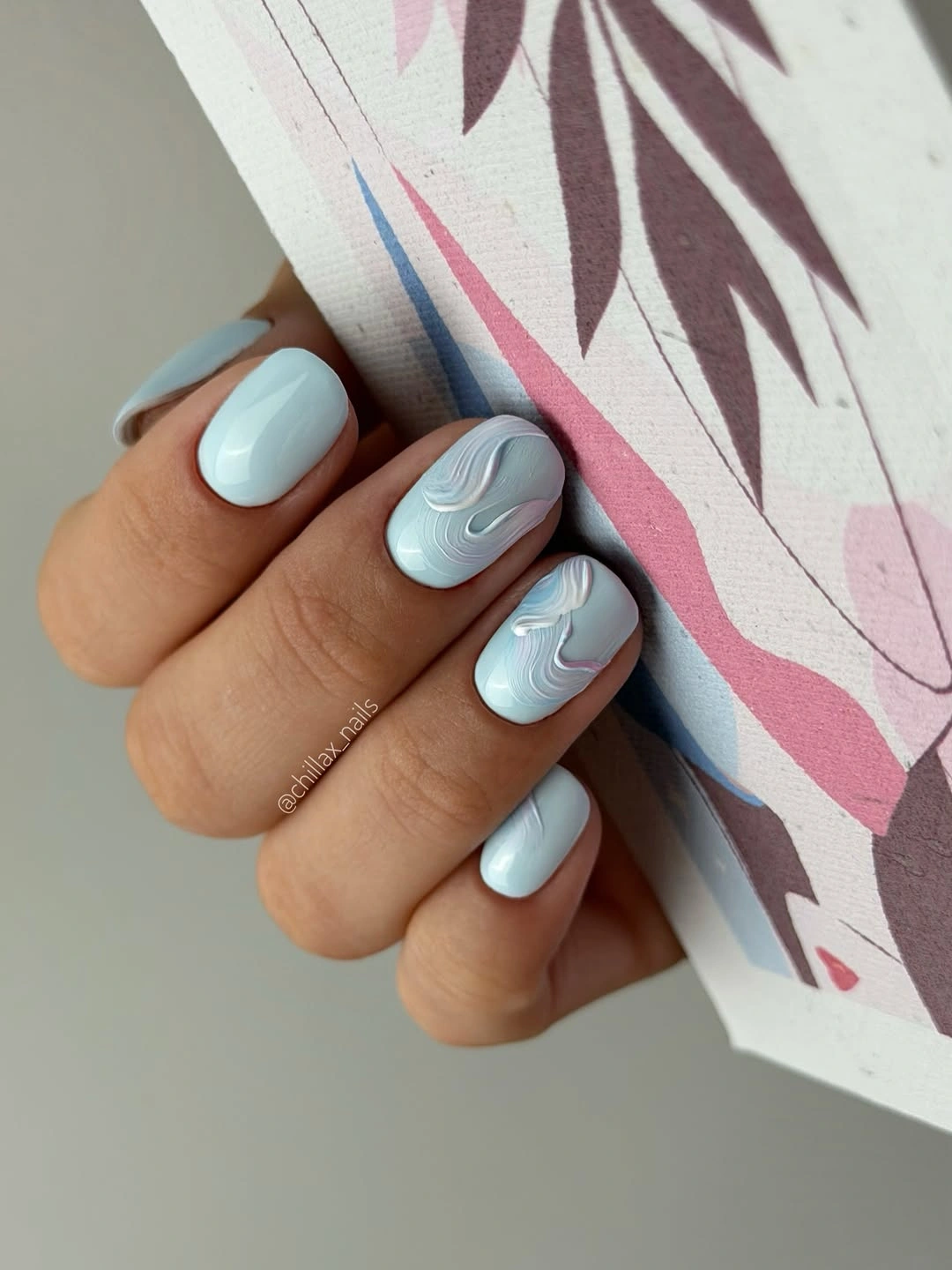 Short square pale blue nails with layered white waves