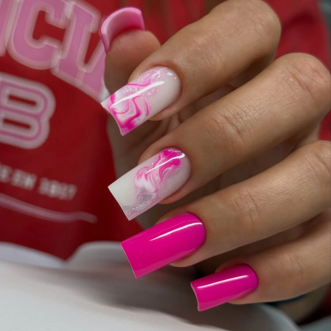 Long square hot pink nails with pale pink swirl accents
