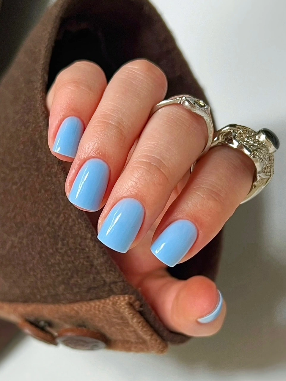 Medium short square nails in a glossy sky blue shade