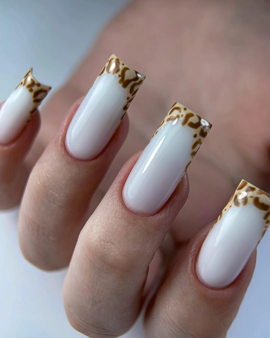 Milky square nails with brown animal print French tips