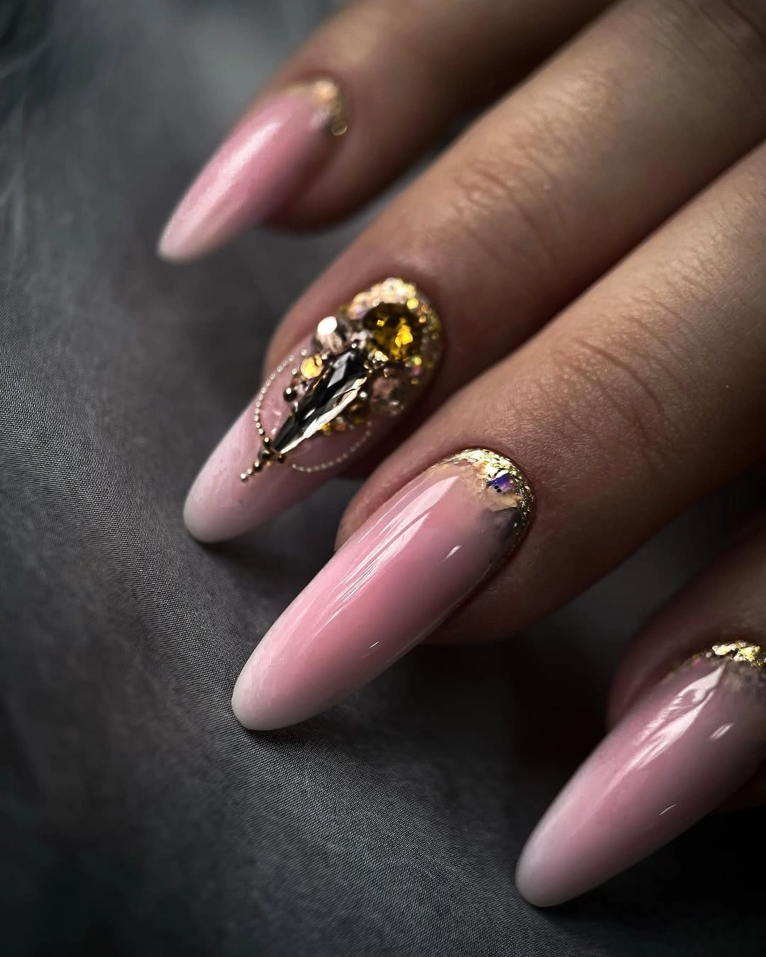 Pink almond nails with one jeweled gold accent
